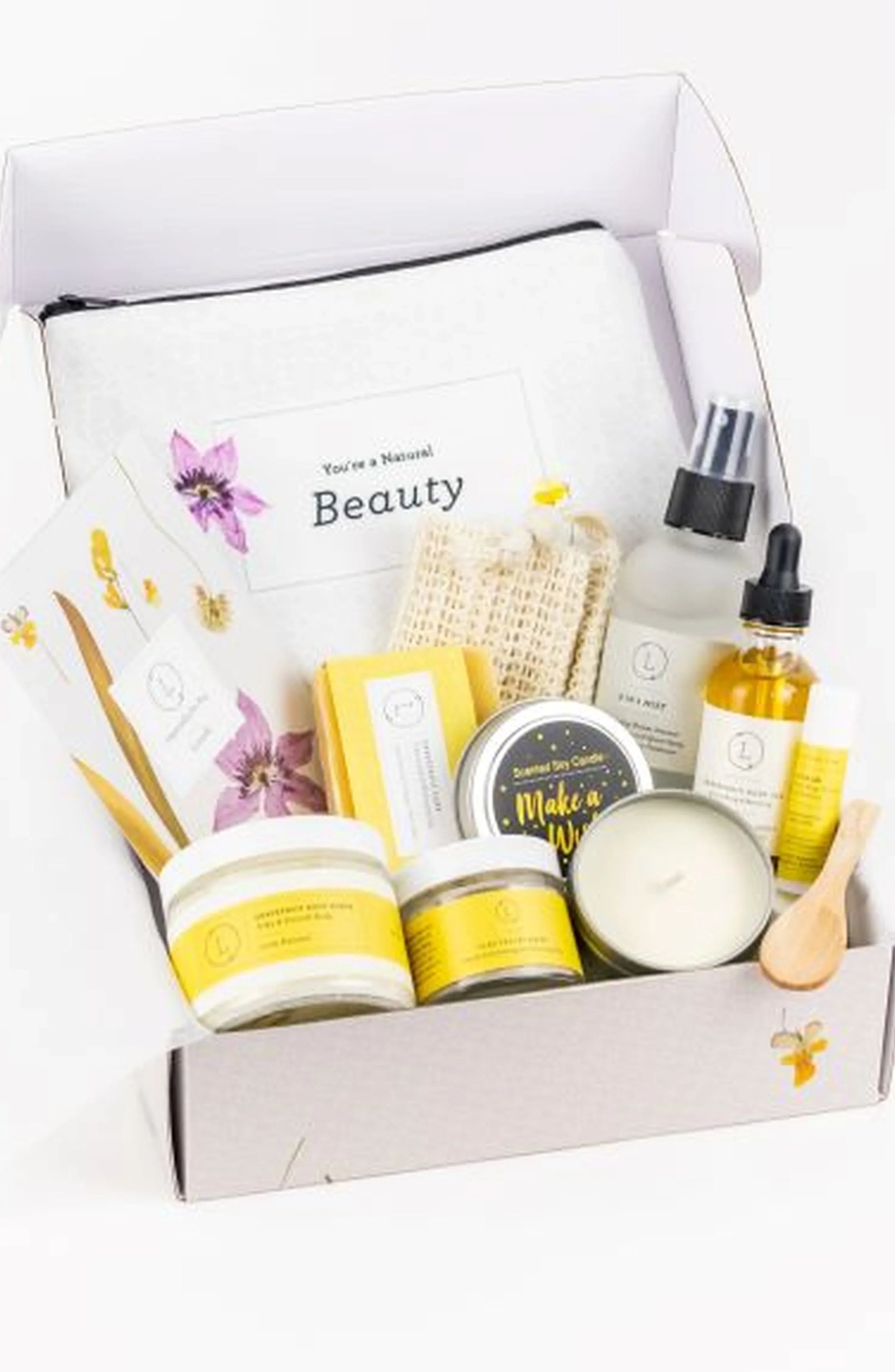 Natural beauty gift box with skincare products, soap, scented candle, and cloth pouch