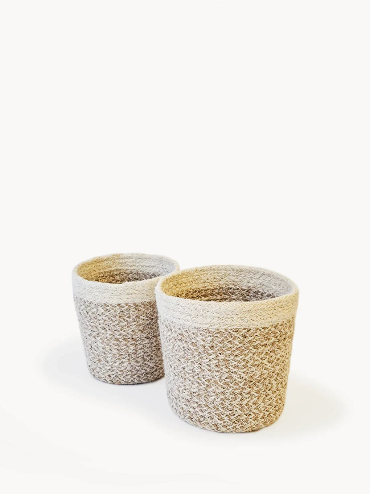 Two white woven agora plant baskets in different sizes on white background