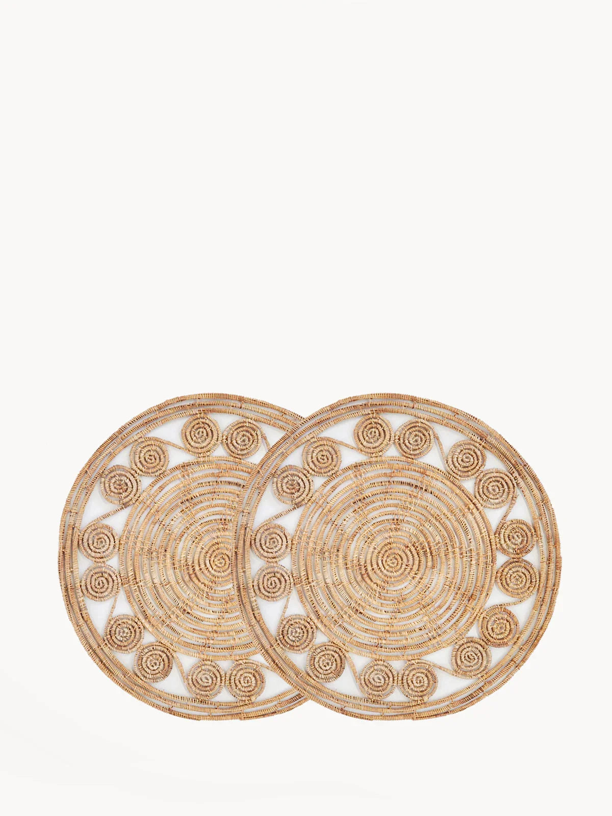 Two round natural woven palm fiber placemats with spiral designs, set of 2 on white background