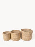 Set of three natural woven jute storage baskets in small, medium, and large sizes
