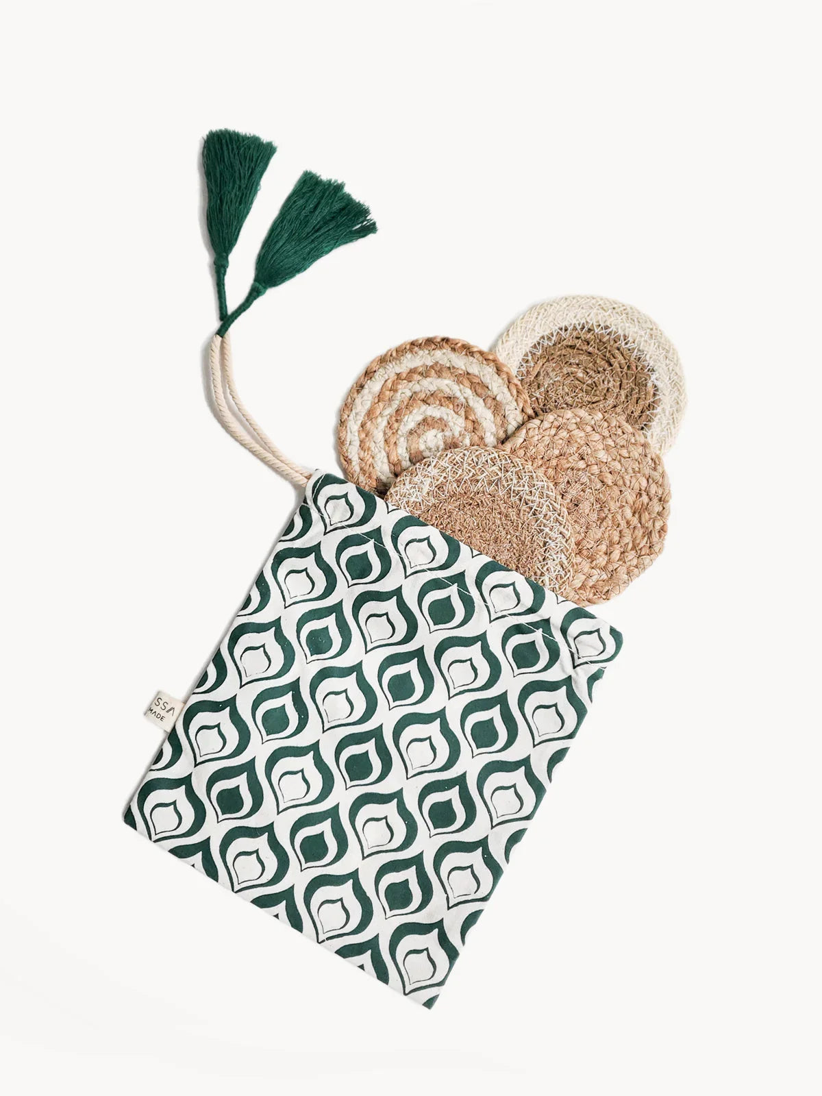 Set of four natural fiber mini coasters in a green and white patterned pouch with green tassels