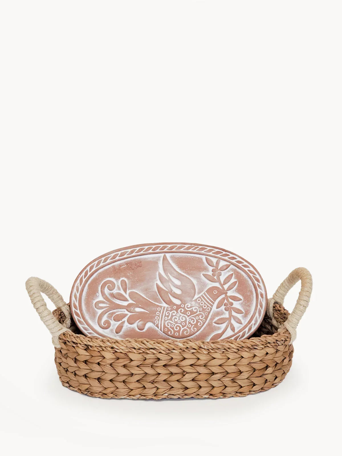 Woven bread warmer basket with oval terracotta tile featuring a dove holding an olive branch