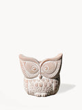 Terracotta owl-shaped planter with intricate carved details and floral patterns on white background