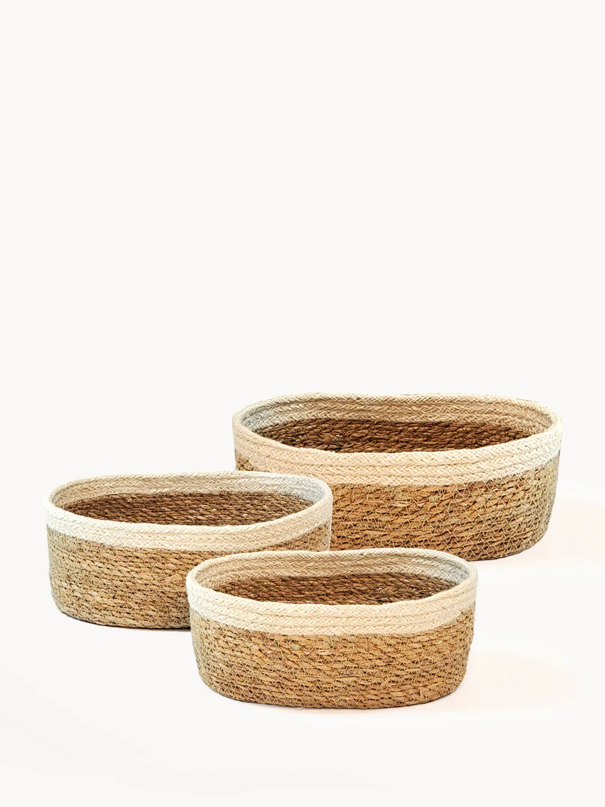 Set of three handmade oval woven baskets with natural two-tone design, Qu!rk Boutique gift shop