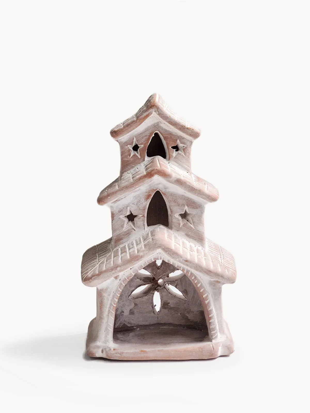 Terracotta candle holder shaped like a two-tier house with star and arched cutouts