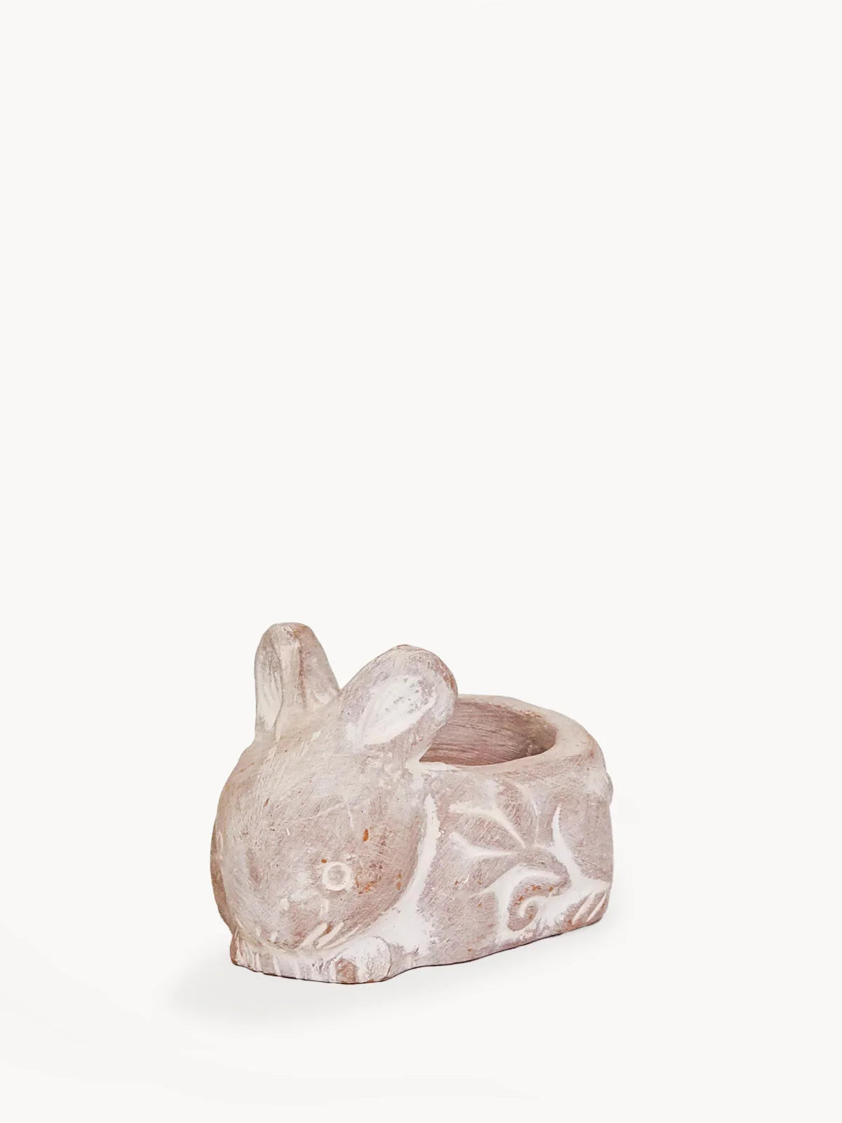 terracotta rabbit-shaped candle holder with carved floral patterns and whitewashed finish