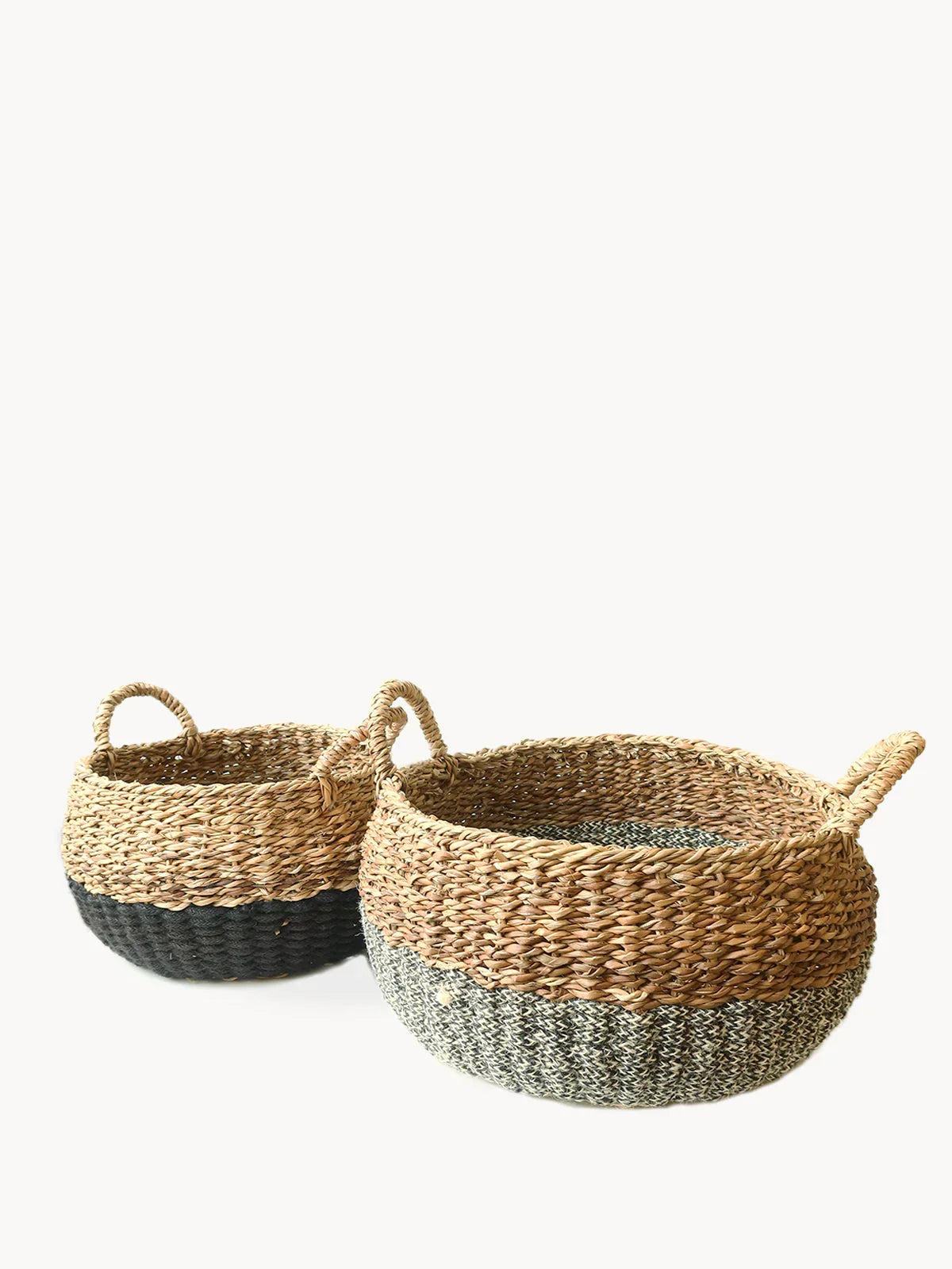 Set of two woven storage baskets with natural and black woven design and loop handles