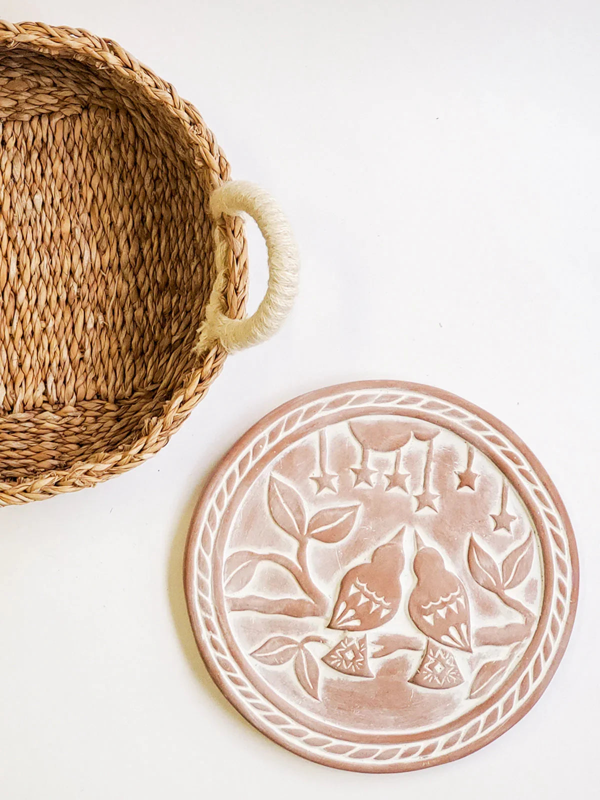 Woven bread basket with a round terracotta bread warmer featuring lovebird design, artist-made gift
