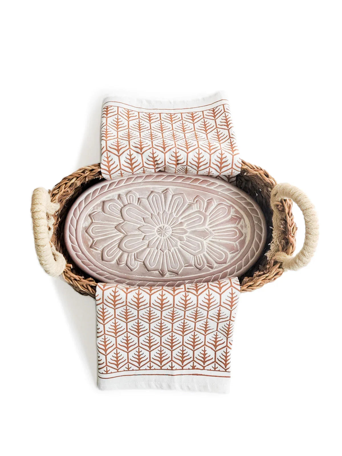 Woven bread warmer basket with floral embossed ceramic insert and patterned tea towel