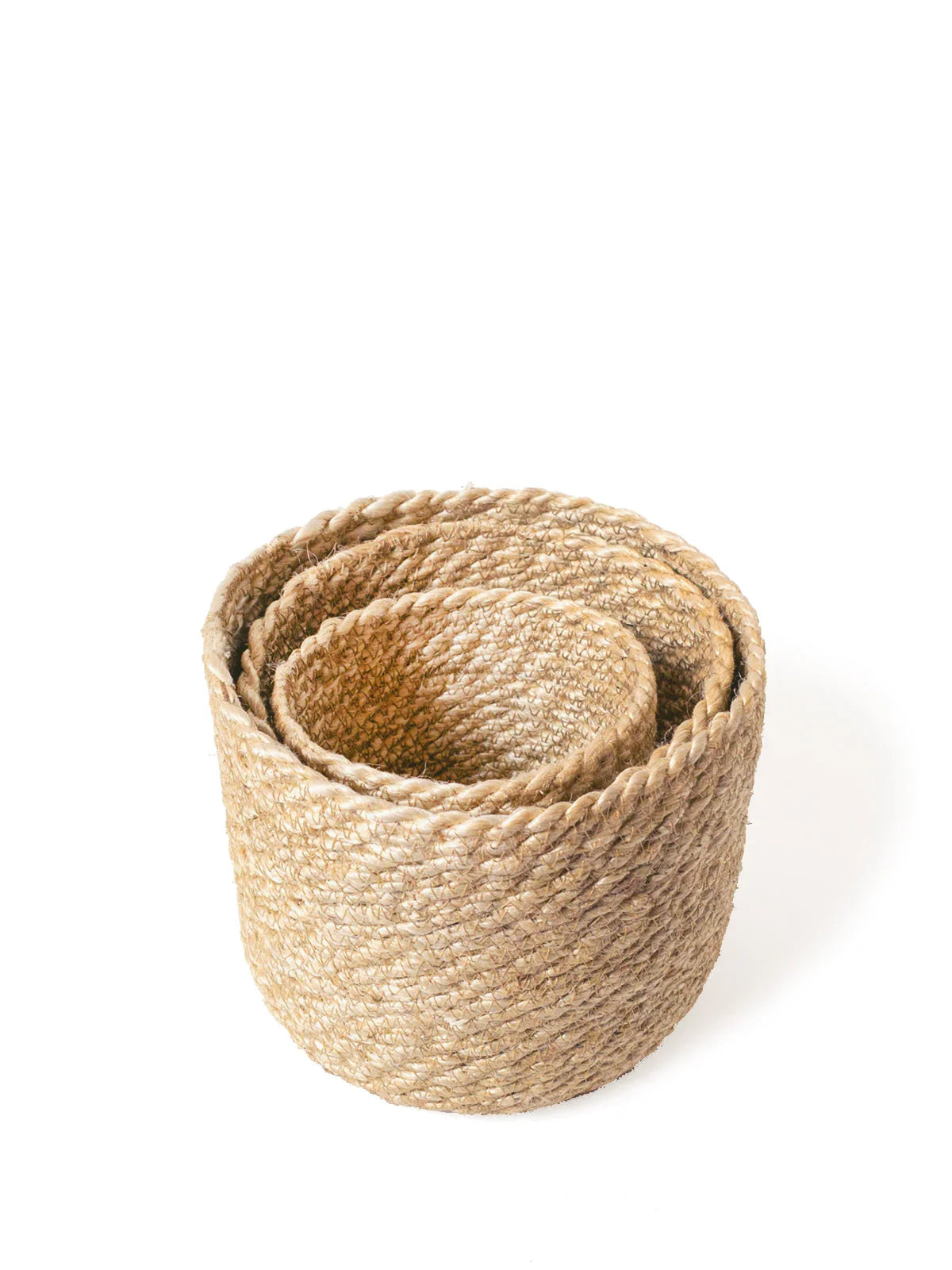 Set of natural woven storage baskets in varying sizes on white background