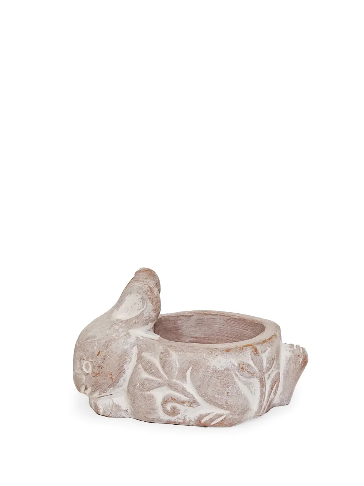 Terracotta rabbit-shaped candle holder with white floral carvings on a white background