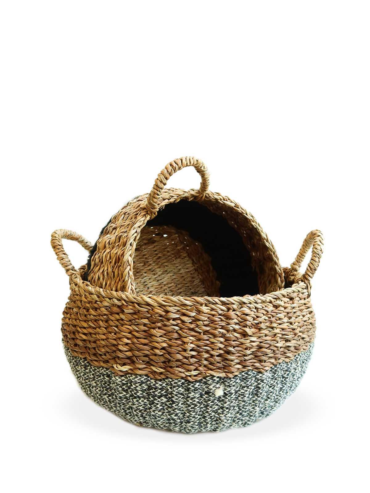 Set of two woven seagrass storage baskets with grey fabric base and handles