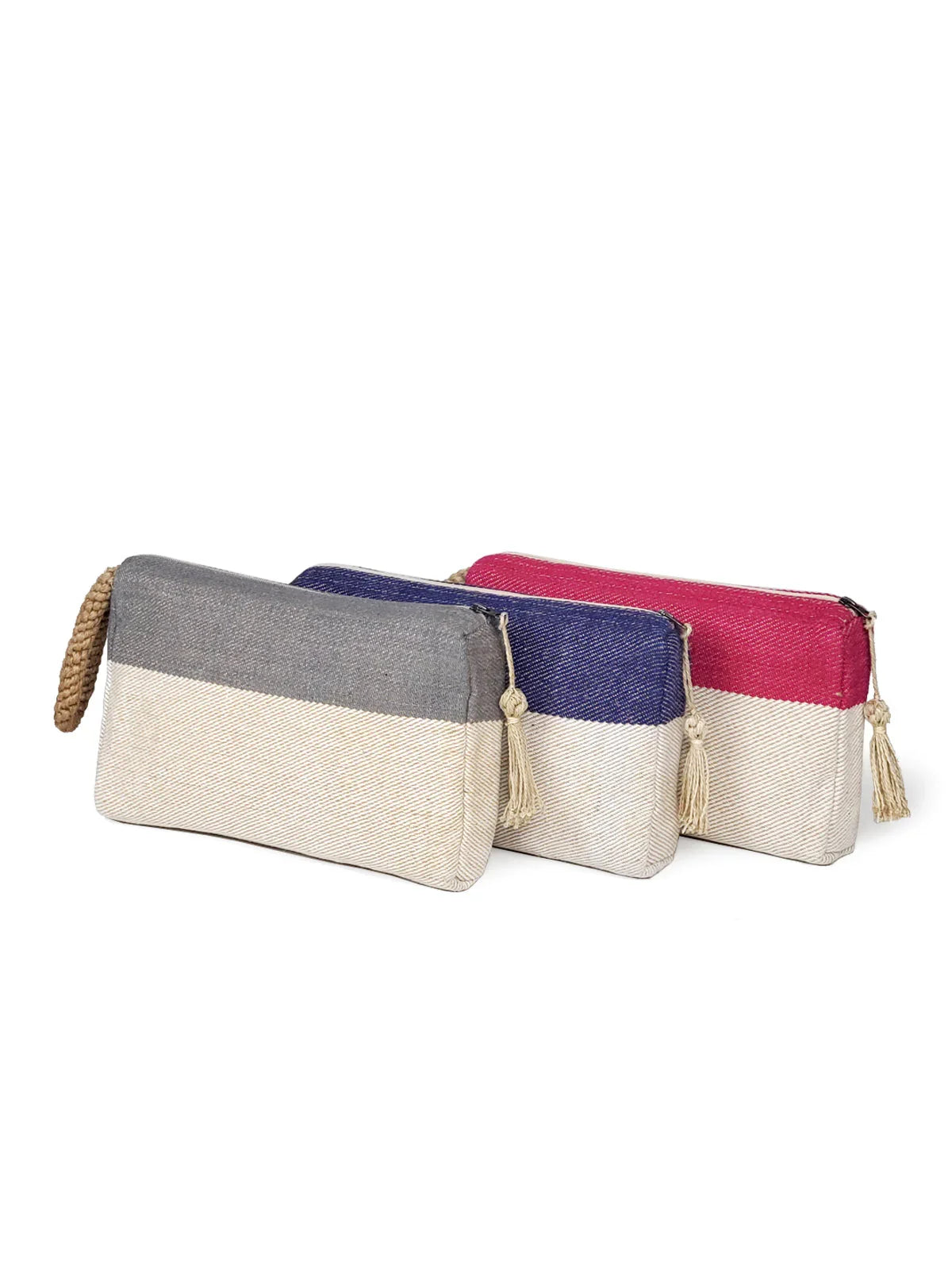 Set of three colorblock canvas clutch bags in gray, blue, and pink with tassel zipper pulls