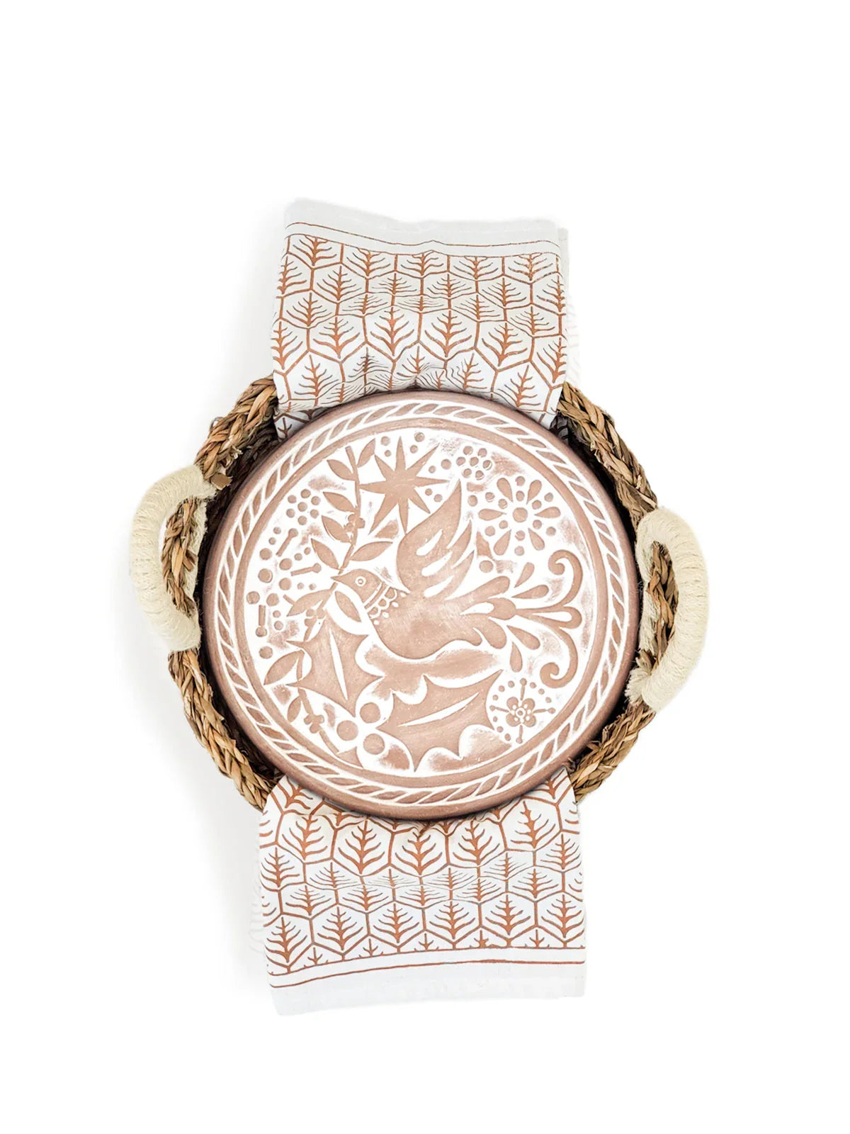 Round bread warmer with bird and nature pattern on lid, woven basket with handles, and patterned tea towel