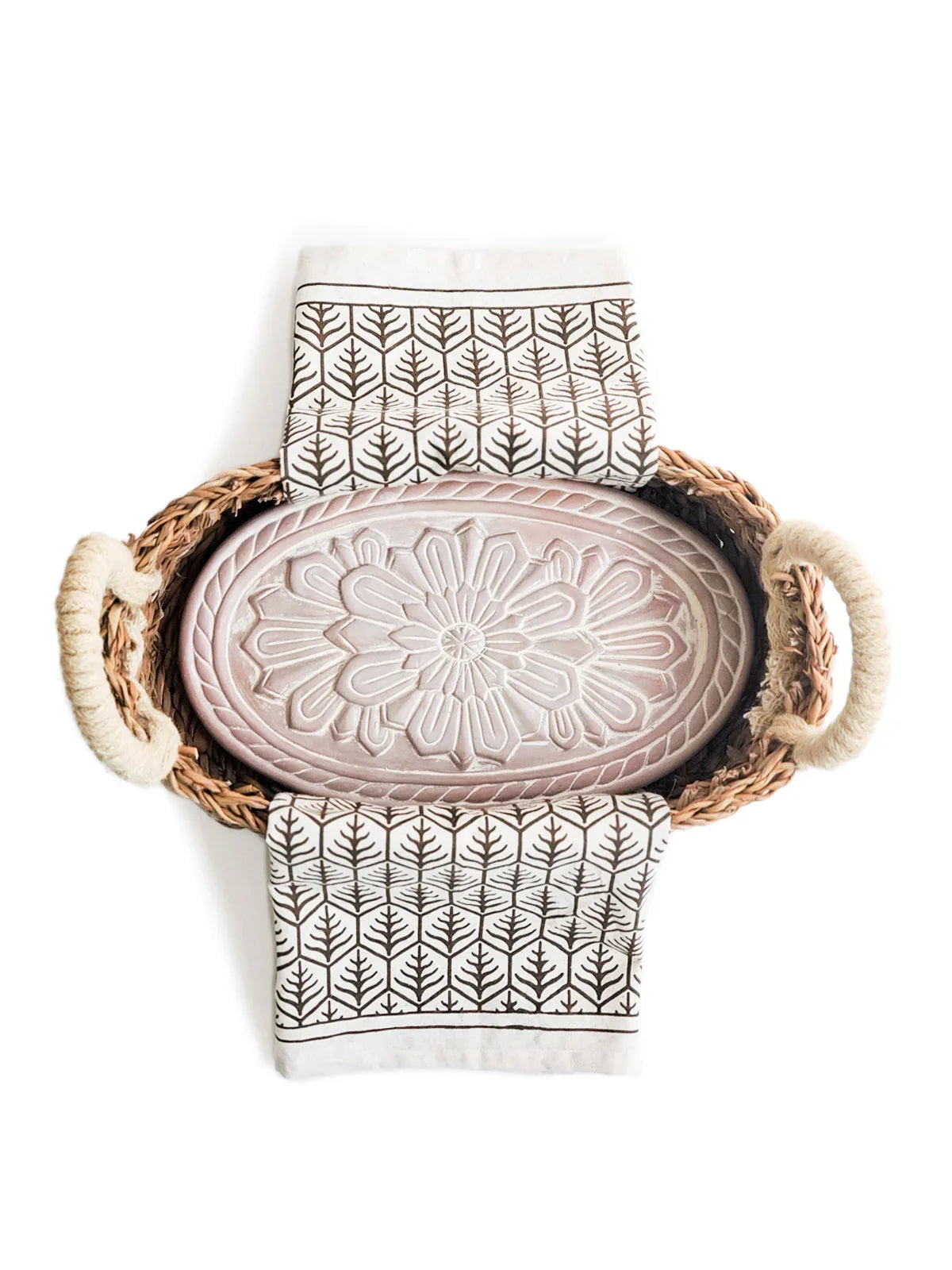 Handcrafted bread warmer with floral design in woven basket and patterned tea towel