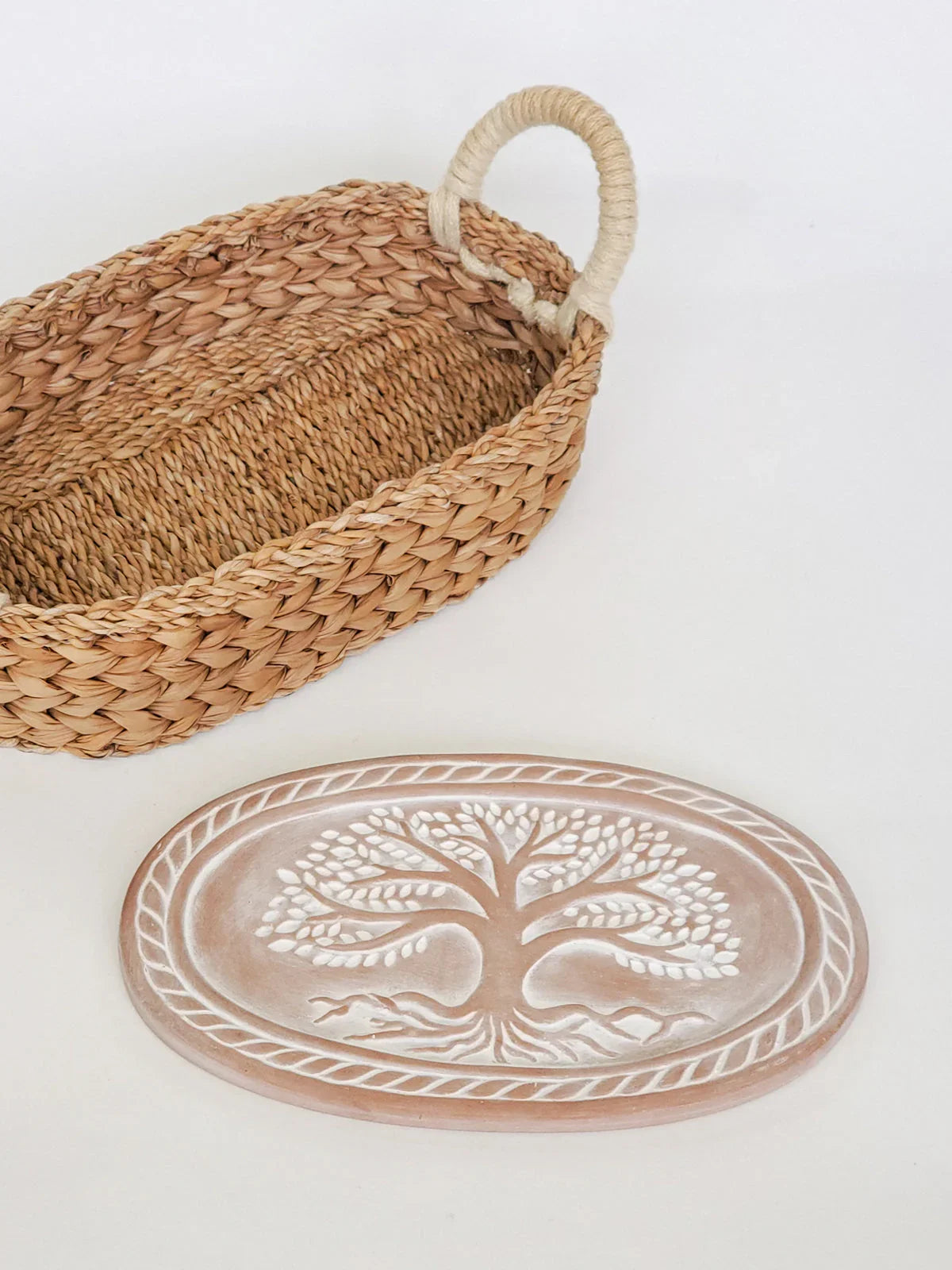 Oval woven bread basket with rope handle and oval bread warmer featuring embossed Tree of Life design
