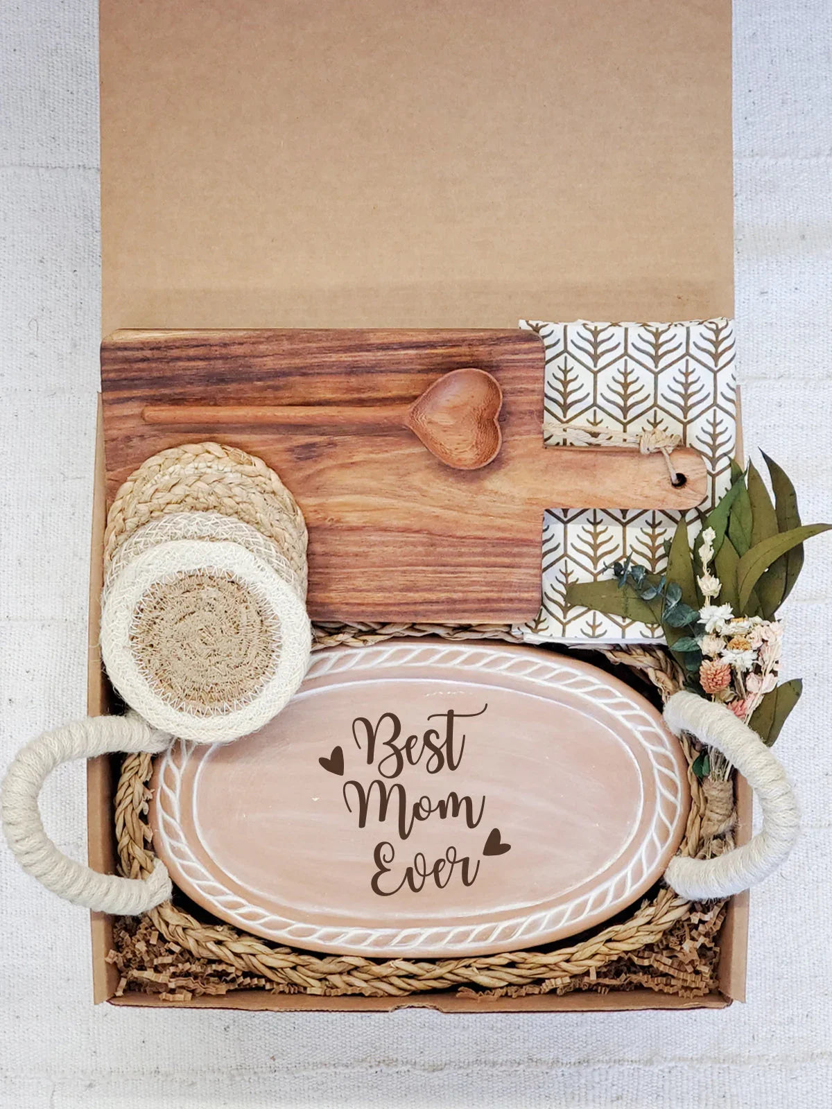 Gift box with Best Mom Ever oval wooden tray, heart-shaped spoon, napkin, coasters, and dried flowers