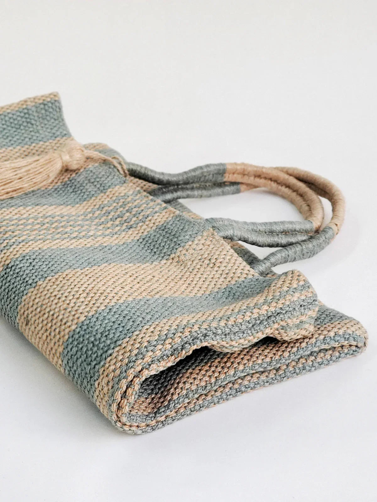 Eco-friendly pale green and beige striped jute tote bag with braided handles, Qu!rk Boutique