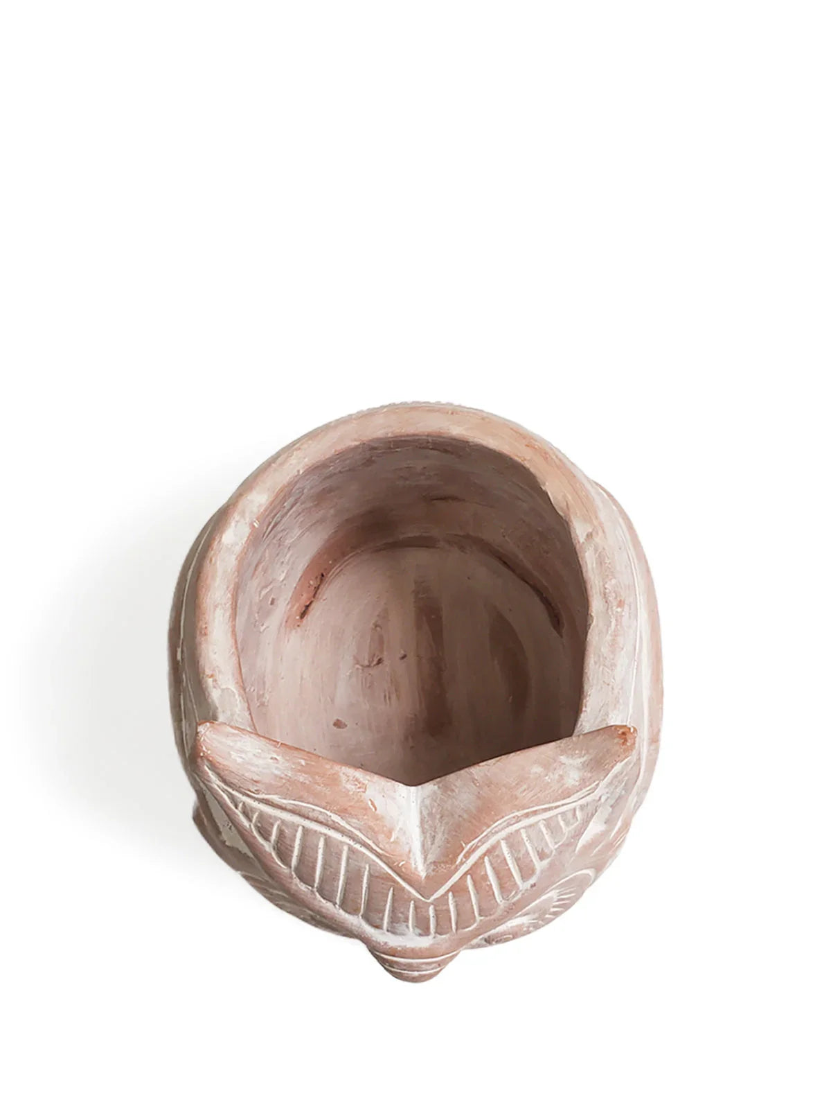 Top view of terracotta owl-shaped planter with carved details on white background