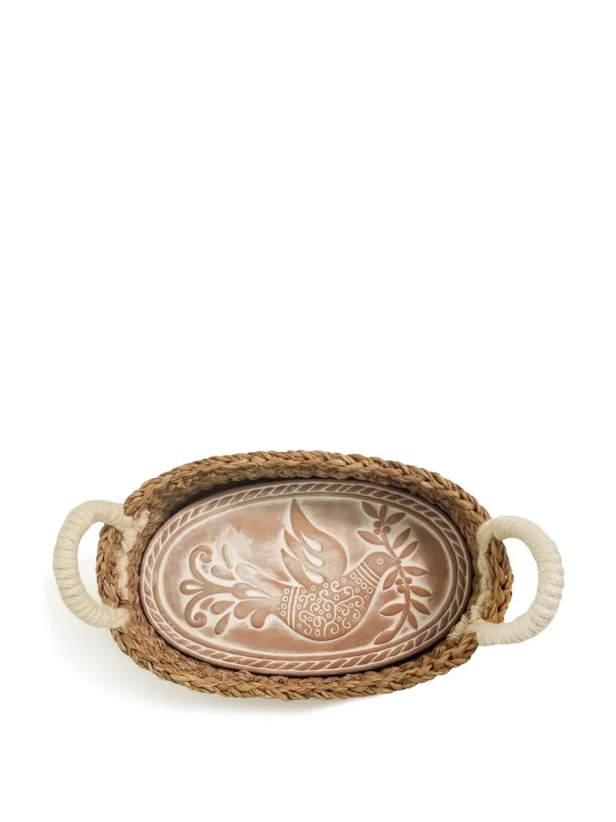 Oval braided bread warmer basket with rope handles and decorative bird design in warm tones