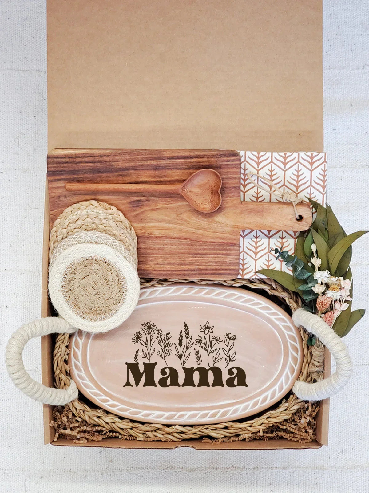 Mother's gift box with wooden Mama plate, heart-shaped spoon, cutting board, coasters, and dried flowers