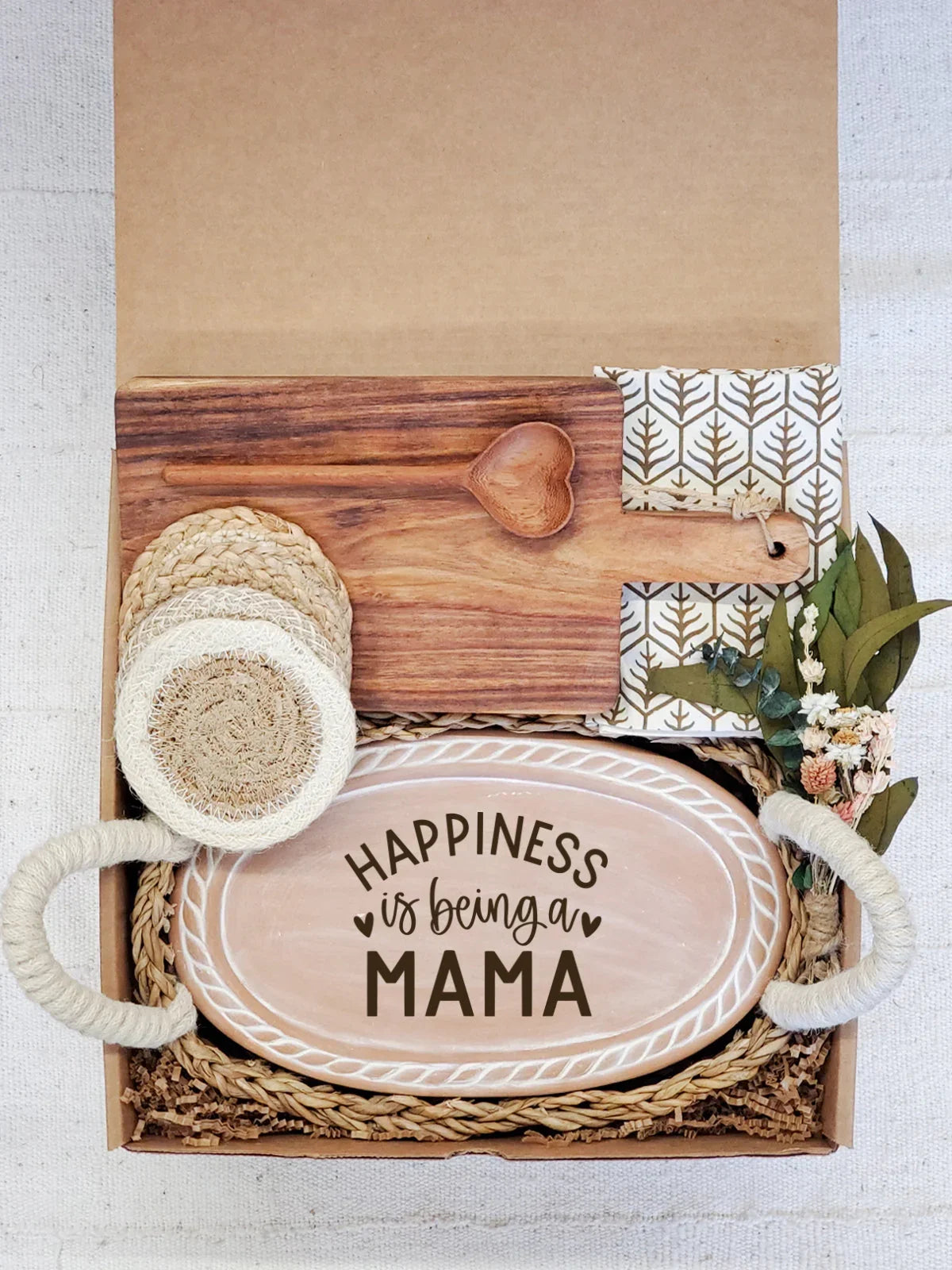 Gift box with wooden heart spoon, chopping board, coasters, floral napkins, and 'Happiness is being a Mama' tray