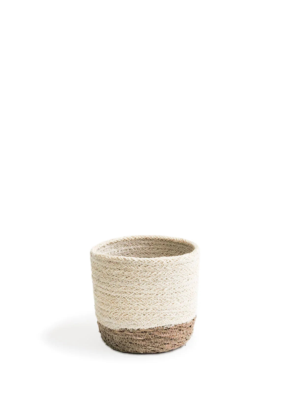 Small woven storage basket with cream upper and brown base on white background