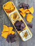 Colorful tortilla chips with creamy hummus and seasoned dip on rustic wood, Qu!rk Boutique style
