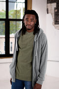 Man in casual green tee and grey hoodie models sustainably bold fashion at Qu!rk Boutique