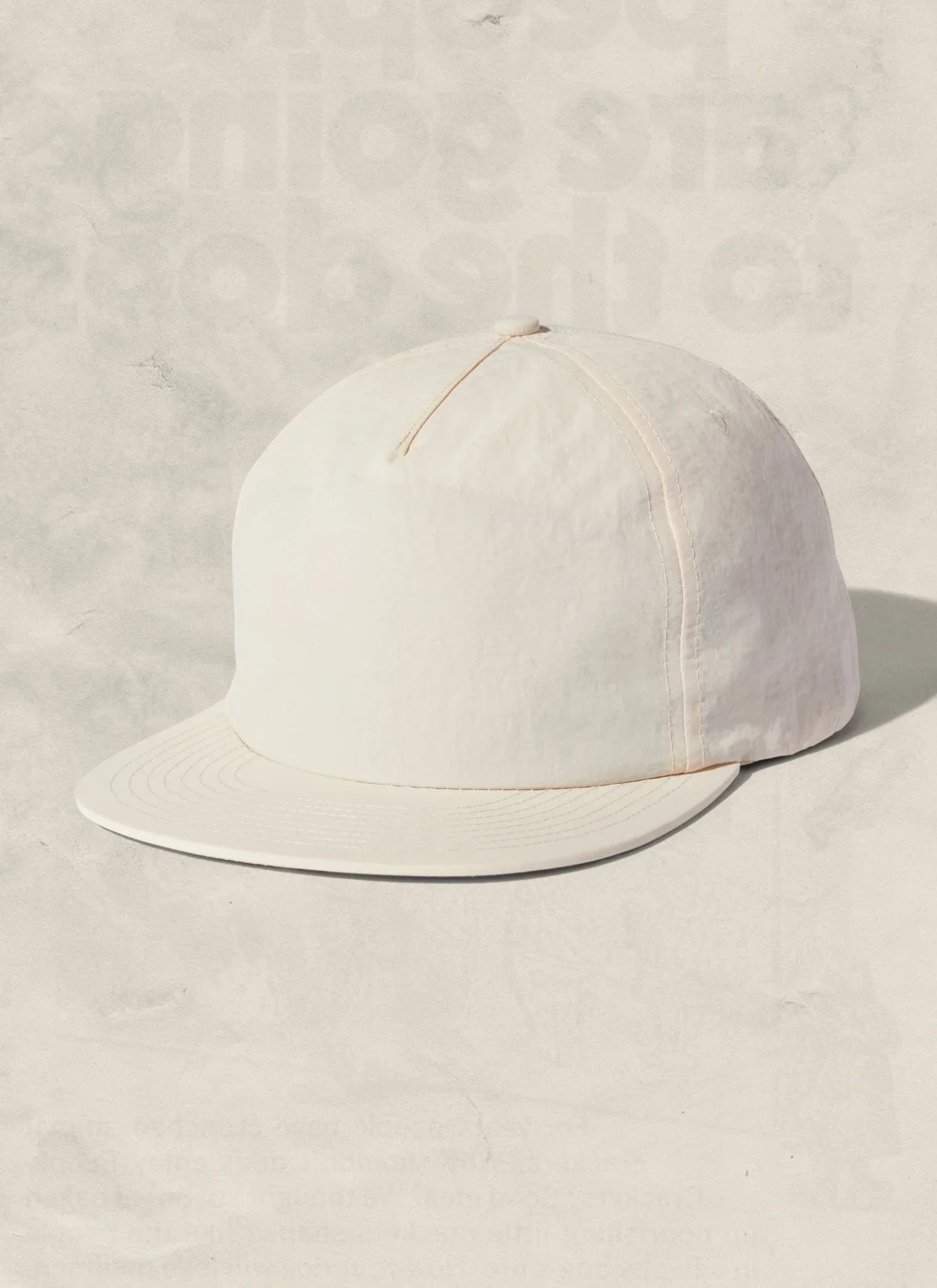 Minimalist white cap with curved brim on neutral background, Qu!rk Boutique artist-designed accessory
