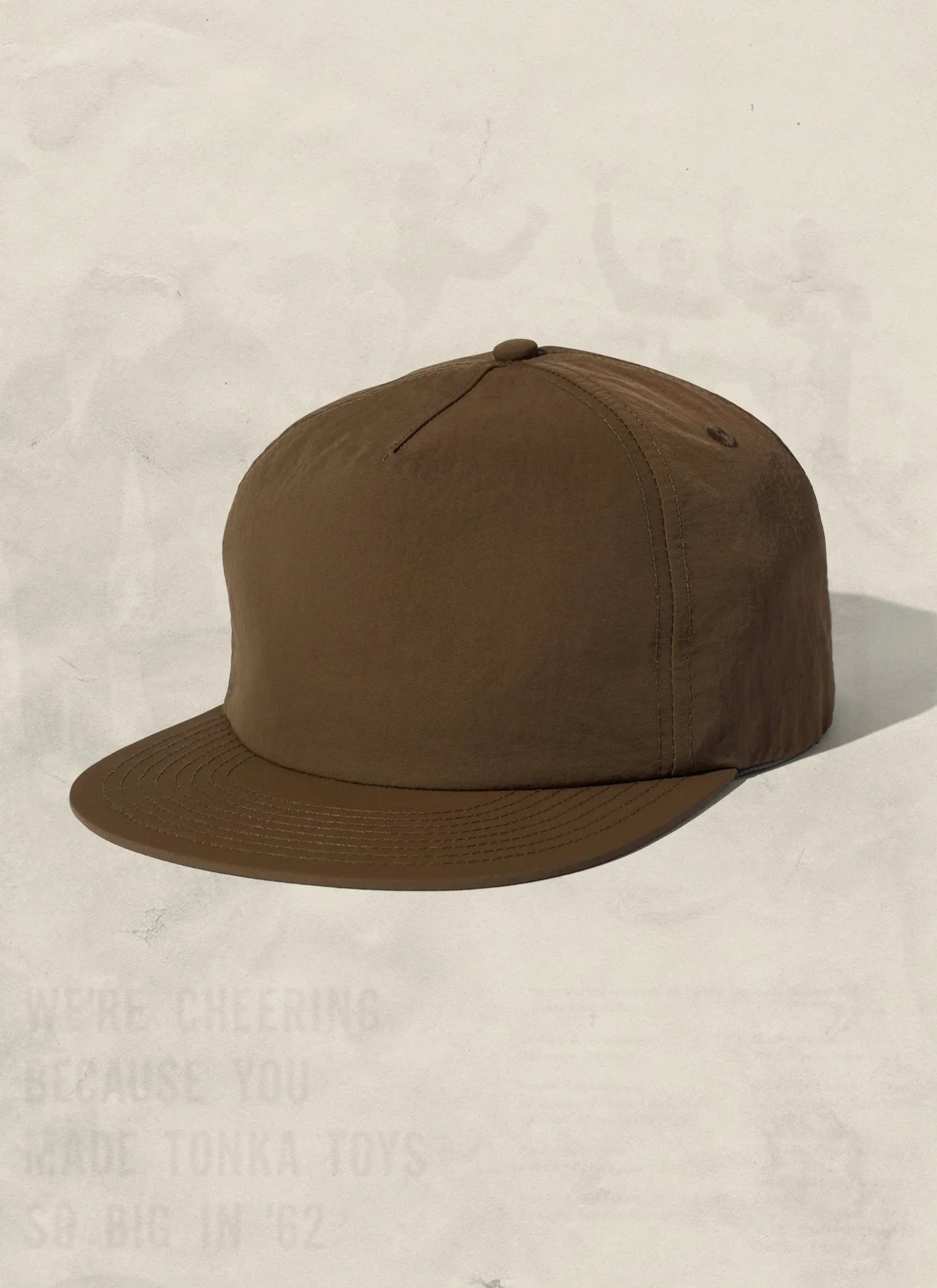 Brown minimalist baseball cap on neutral background, Qu!rk Boutique ethical accessories