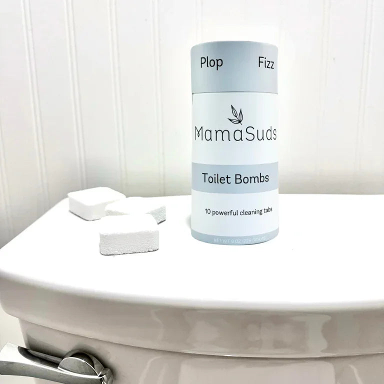 MamaSuds Toilet Bombs eco-friendly cleaning tabs on a white toilet in Qu!rk Boutique style