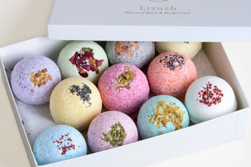 Box of colorful natural bath bomb set with dried flower and herb toppings