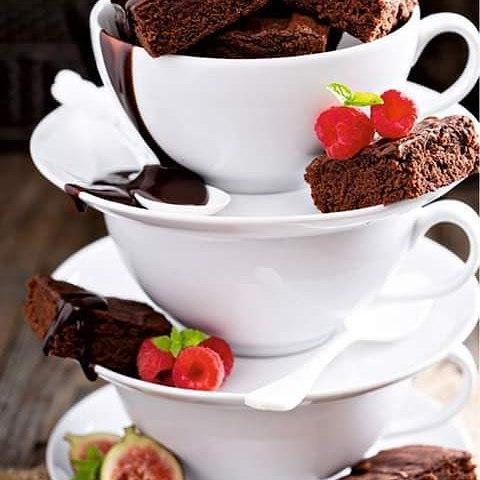Stacked white teacups with brownies, fresh raspberries, and chocolate drizzle, Qu!rk Boutique