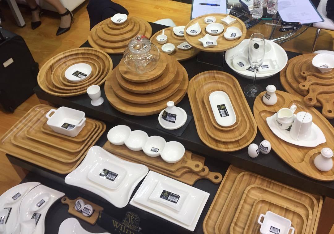 Display of eco-friendly bamboo and ceramic serving trays, plates, and dishes at Qu!rk Boutique