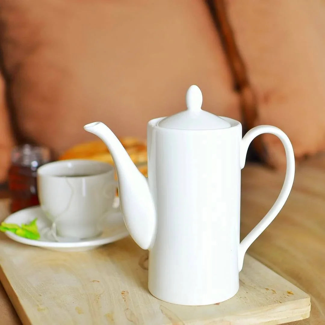White porcelain teapot and teacup on wooden tray, cozy boutique setting, Qu!rk gift shop