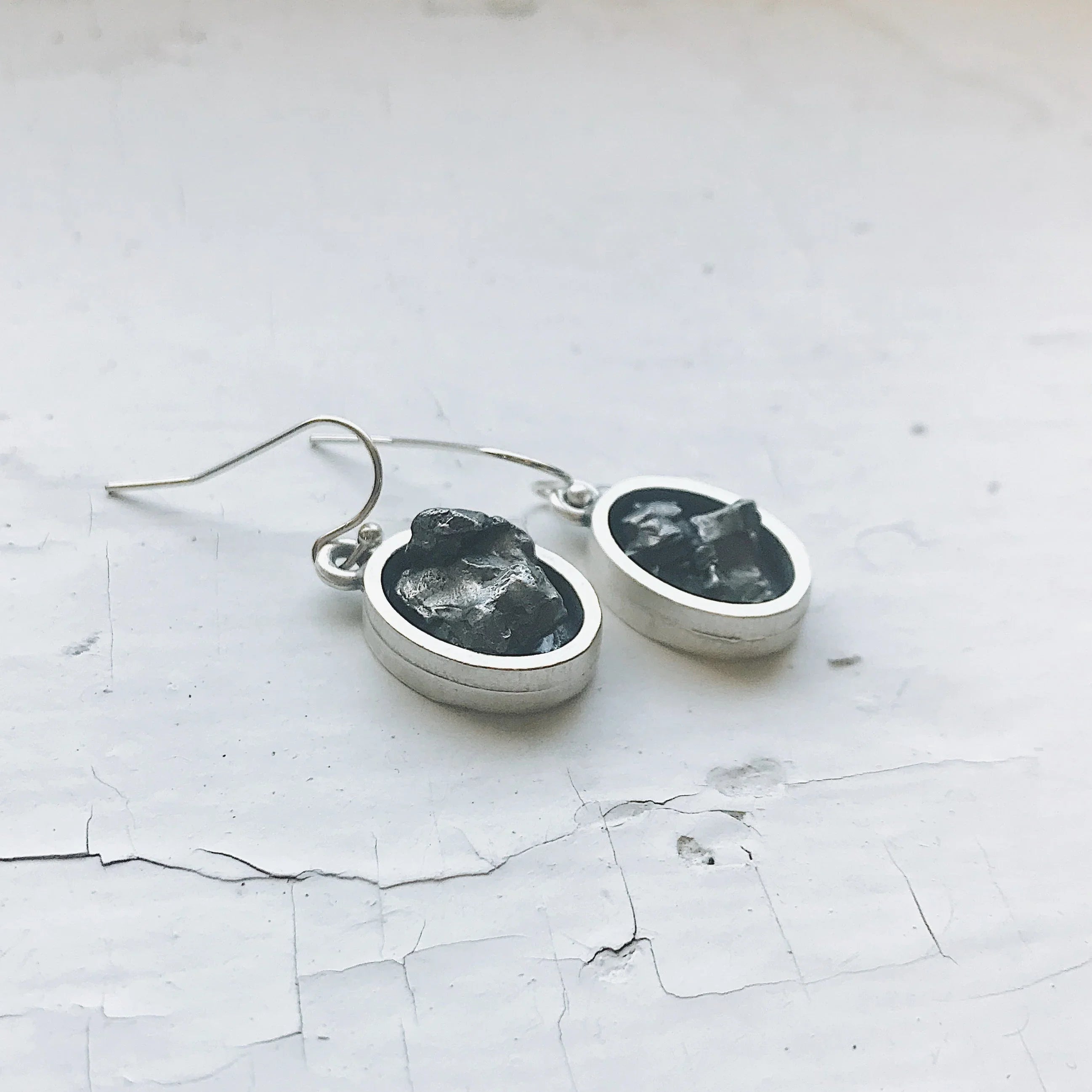 Handmade silver earrings with raw black stones on white background, Qu!rk Boutique jewelry