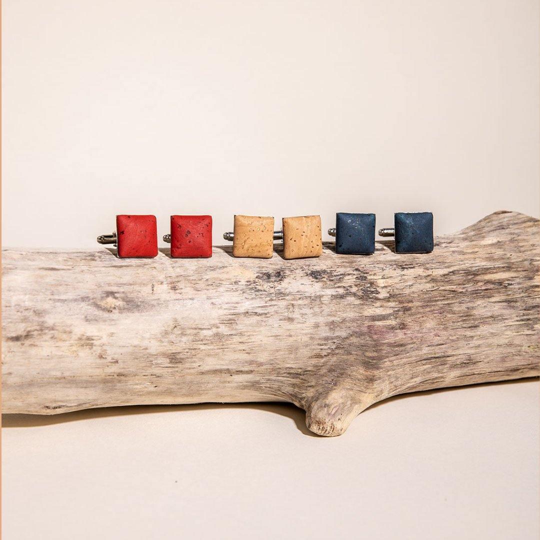 Artisan square cufflinks in red, tan, and blue on driftwood, Qu!rk Boutique gift display.