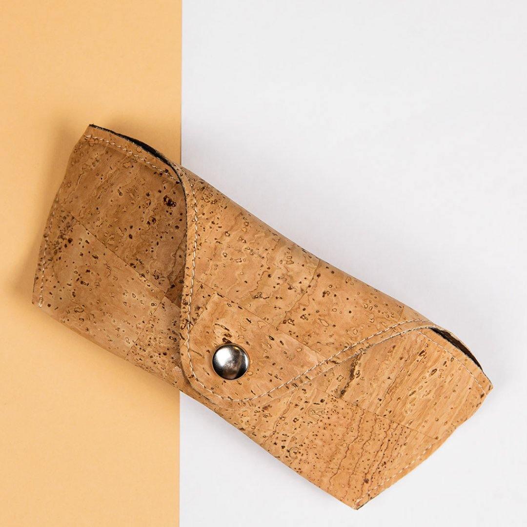 Eco-friendly cork sunglasses case on a peach and white background from Qu!rk Boutique