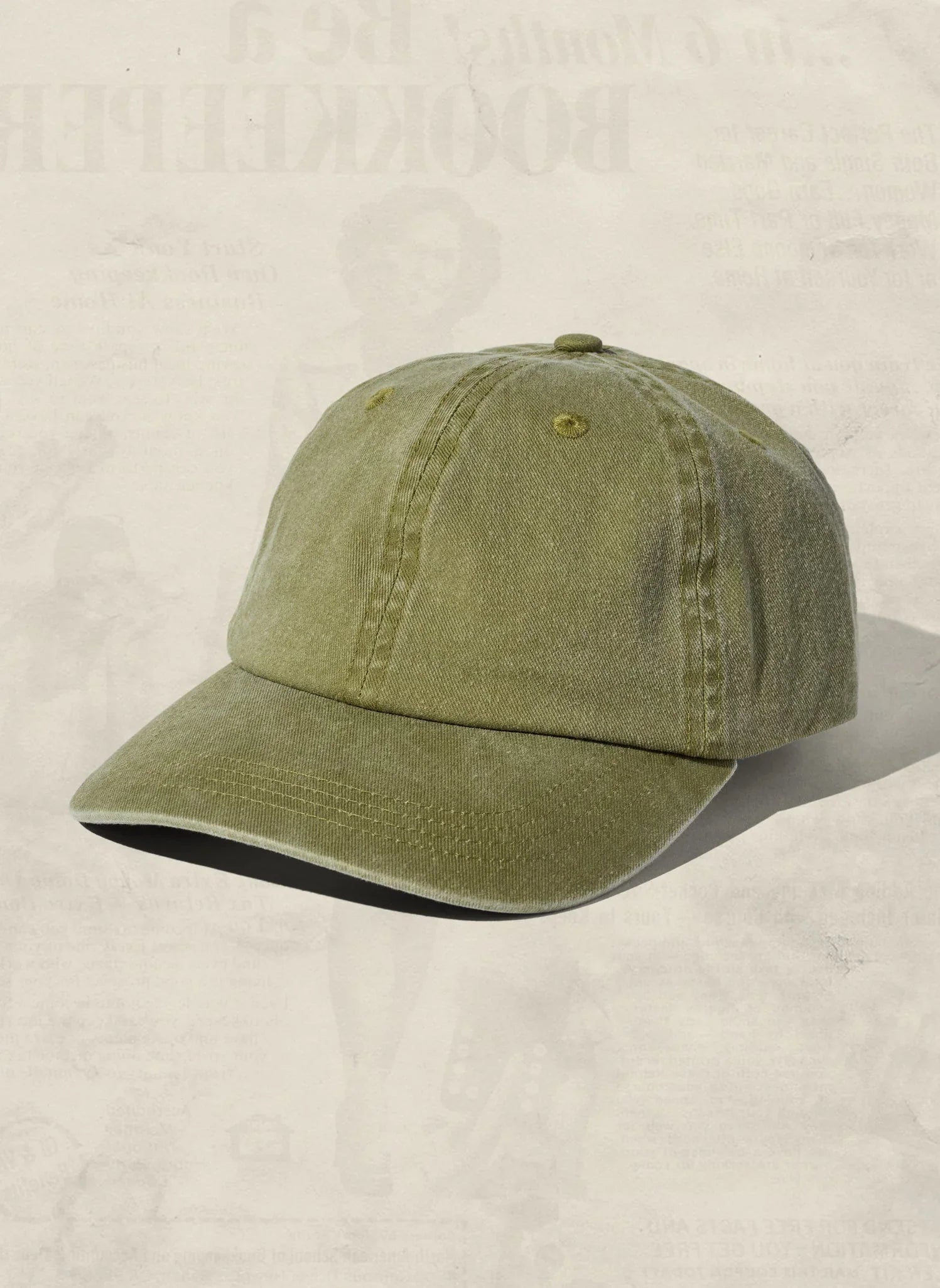 Olive green baseball cap with curved brim, artist-designed from Qu!rk Boutique