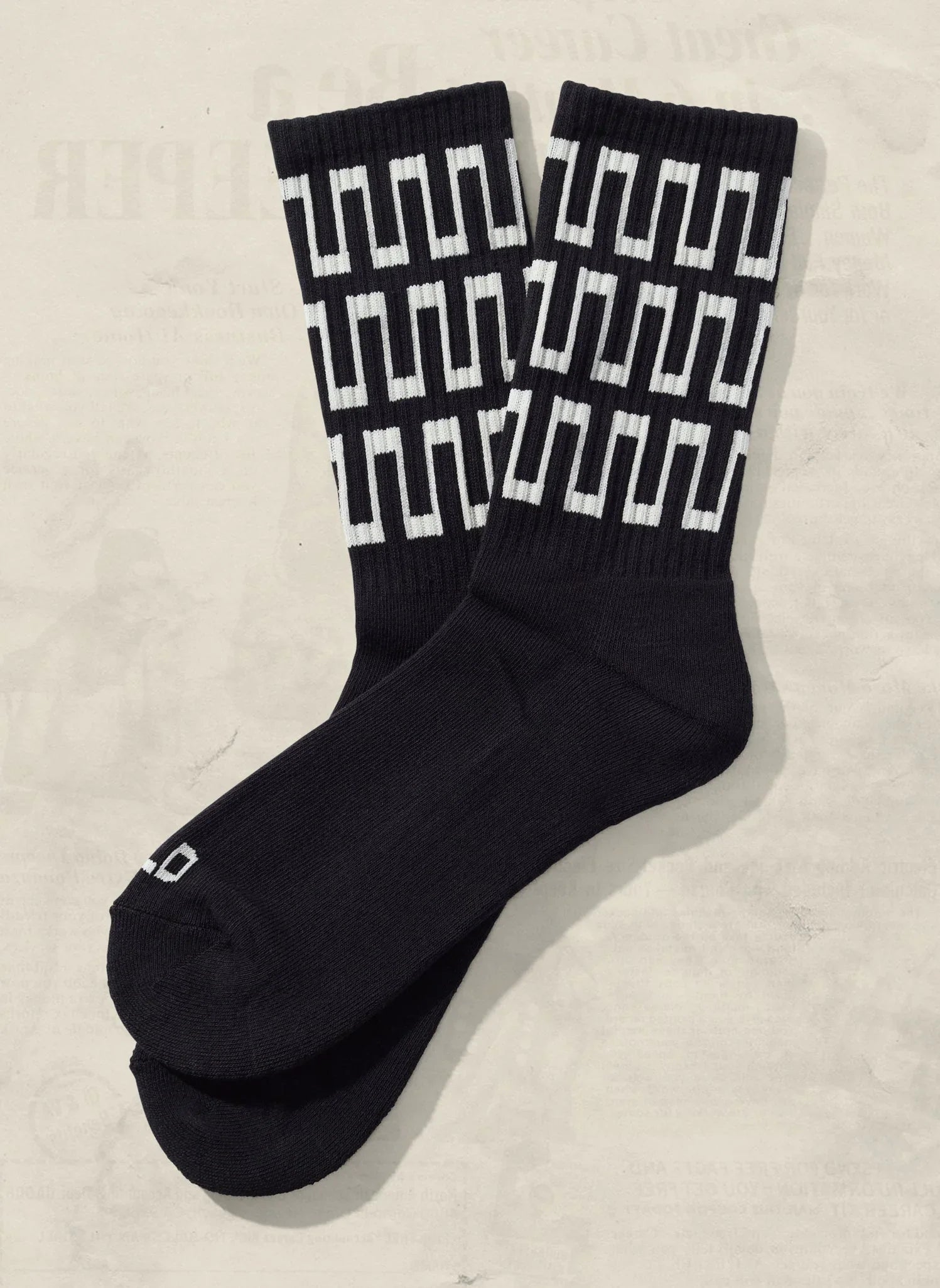 Black crew socks with bold white geometric pattern, artist-designed at Qu!rk Boutique
