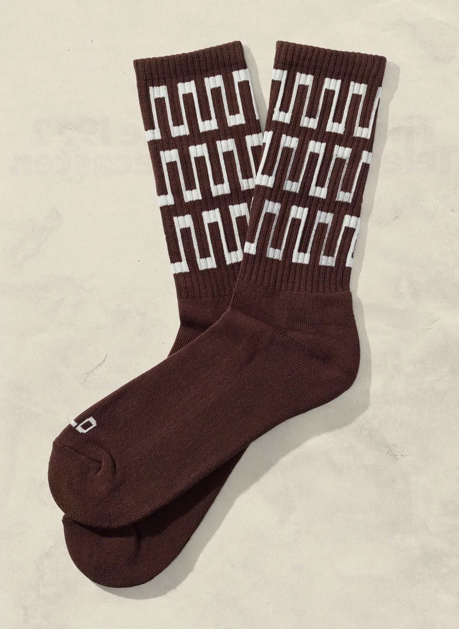 Brown crew socks with white geometric pattern, artist-designed at Qu!rk Boutique