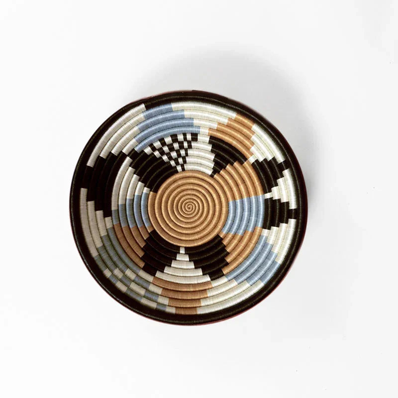 Overhead view of a medium woven bowl in beige, black, blue, and white at Qu!rk Boutique