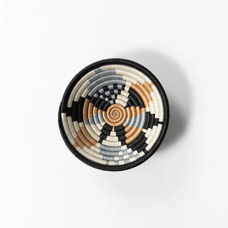 Overhead view of a small gray, black, tan, and cream woven bowl from Qu!rk Boutique