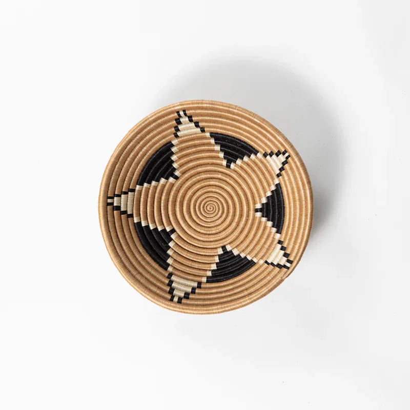 Overhead view of a medium woven bowl with star pattern, artisan home decor from Qu!rk Boutique