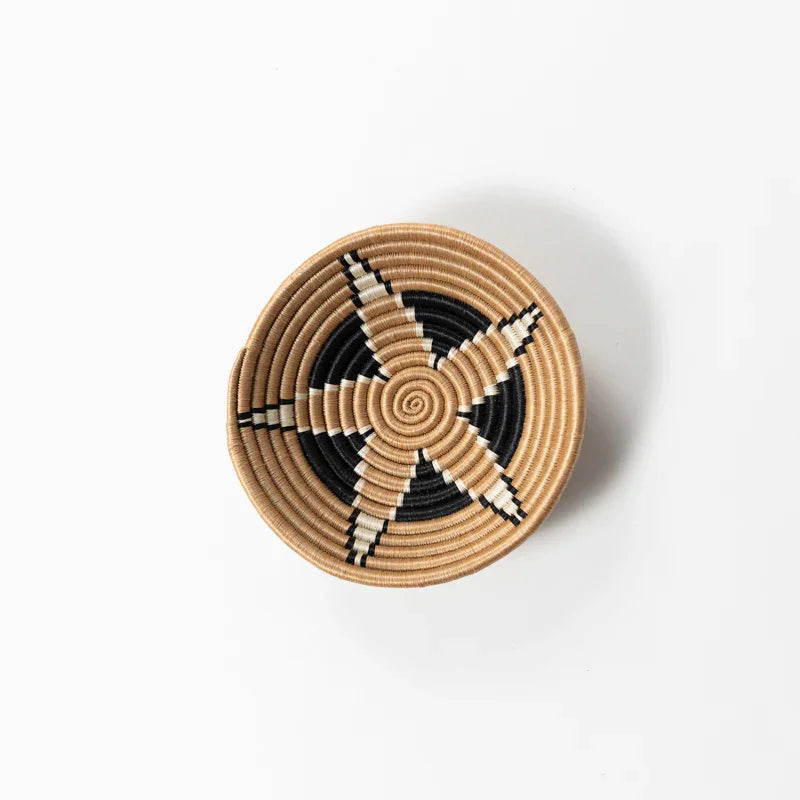 Small woven bowl with black and tan star pattern, artisan home decor from Qu!rk Boutique.