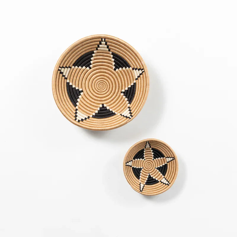 Two woven star pattern bowls, natural and black, artisan home decor at Qu!rk Boutique