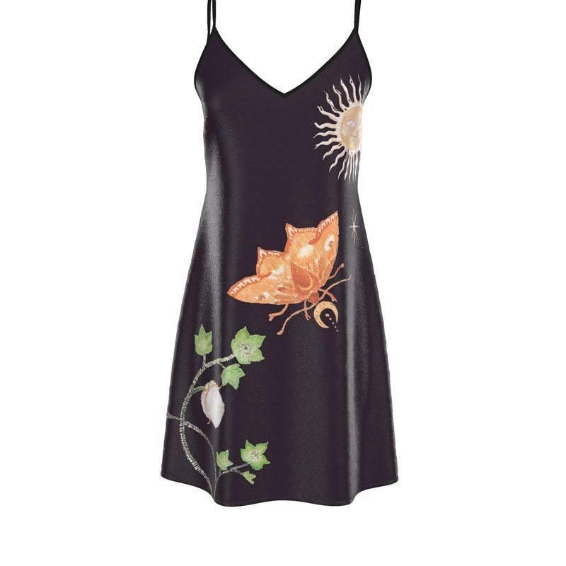 Black slip dress with orange butterfly, sun, moon, and green leaf embroidery design