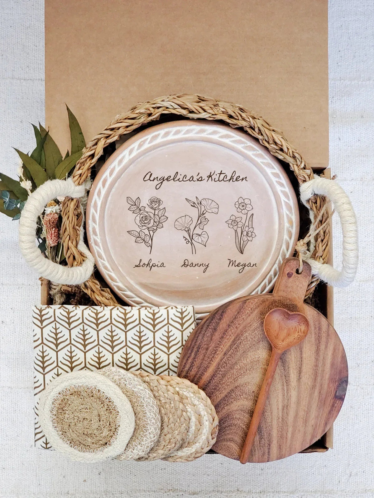 Rustic kitchen gift set with personalized ceramic plate, woven basket, wooden cutting board, and coasters