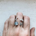Hand wearing silver moon phase and earth stone rings from Qu!rk Boutique & Gift Shop